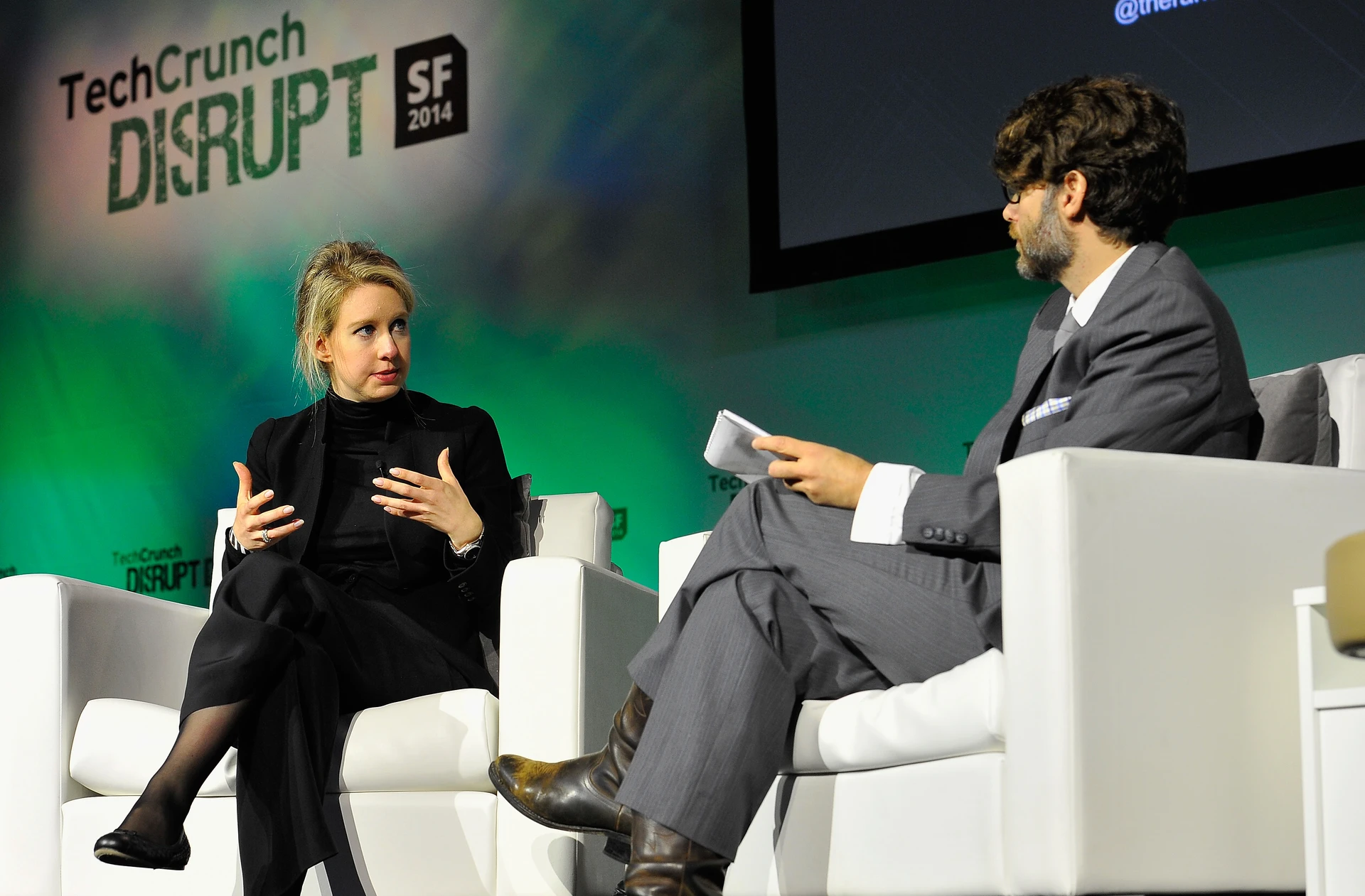 Theranos Chairman, CEO and Founder Elizabeth Holmes (L) and TechCrunch Writer and Moderator Jonathan Shieber speak onstage at TechCrunch Disrupt at Pier 48 on September 8, 2014 (14995888227).jpg